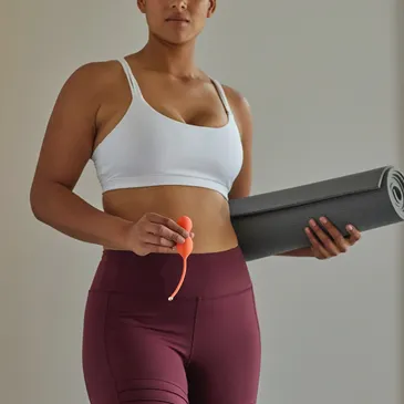 A girl standing while holding a yoga mat